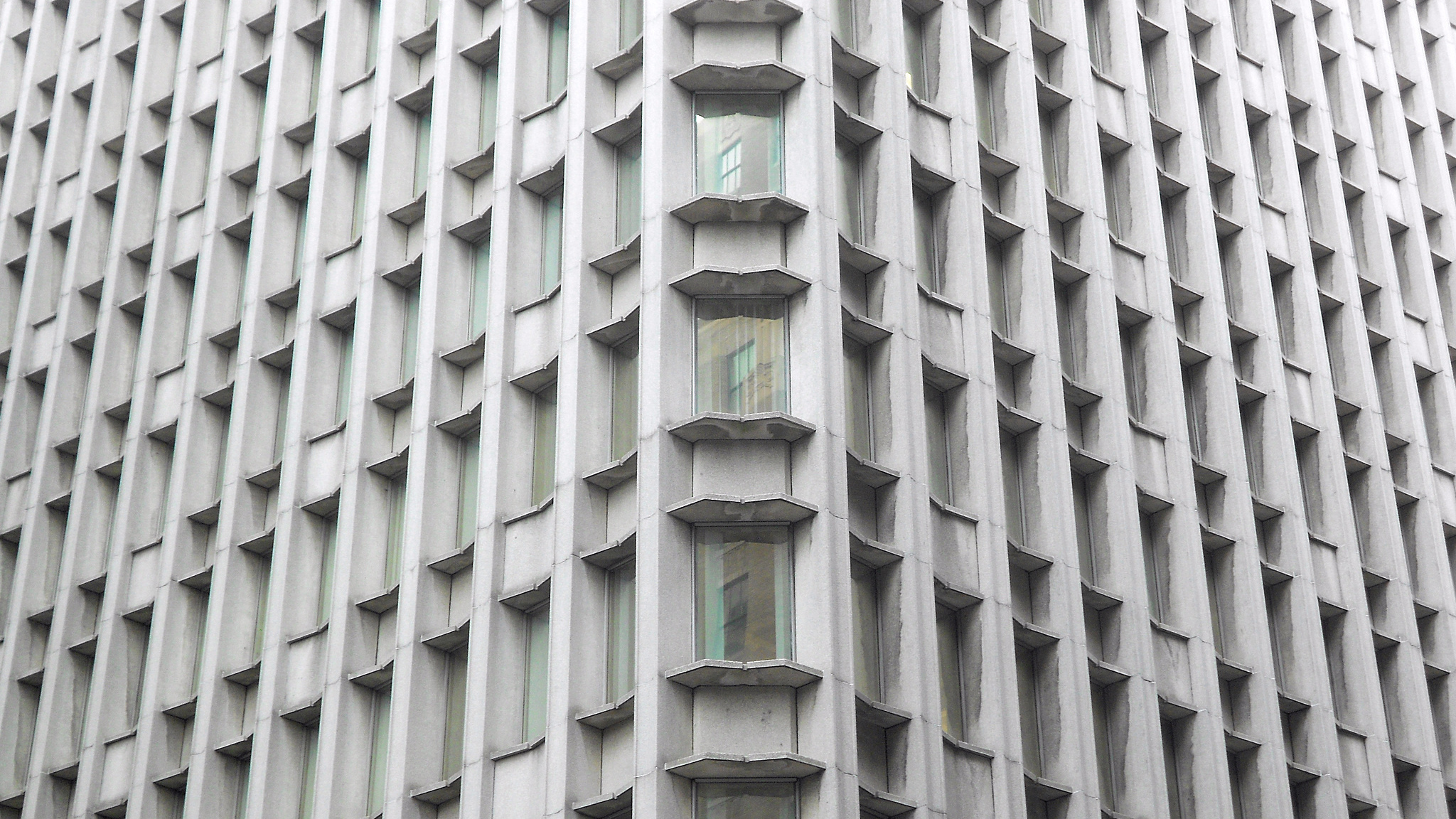 Photo of the angled grid-pattern of windows radiating out from the corner of the Blue Cross Blue Shield building in Boston